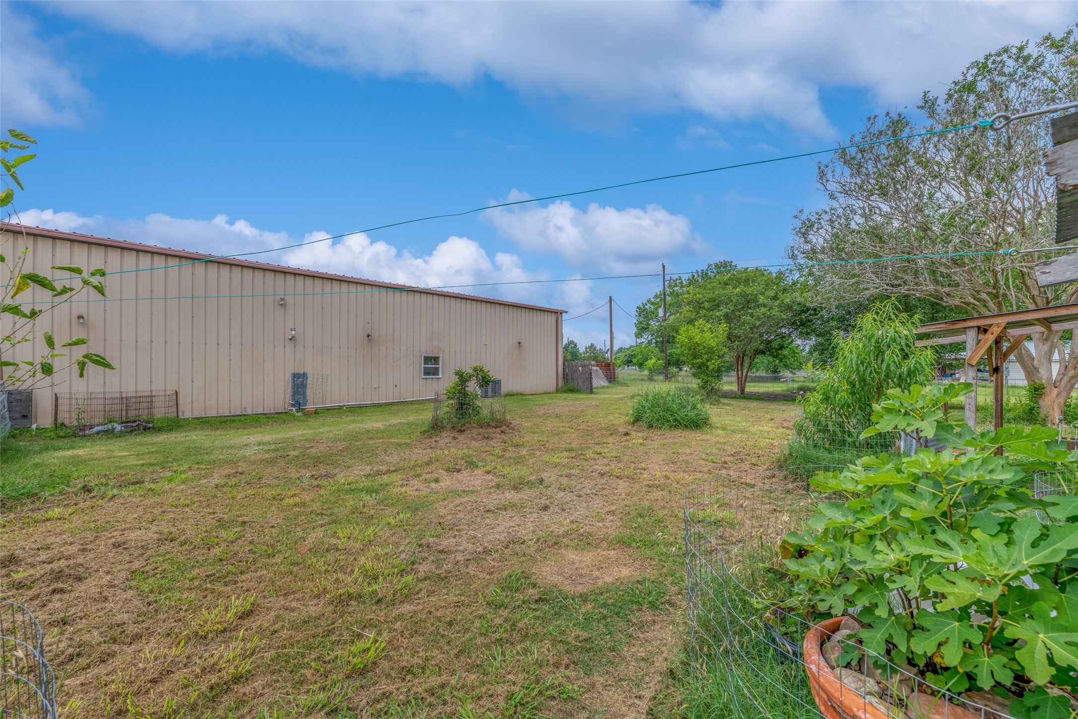 VIEW OF SHOP FROM BACKYARD - If you have additional questions regarding 2055 Green Meadows Drive  in Sealy or would like to tour the property with us call 800-660-1022 and reference MLS# 16848431.
