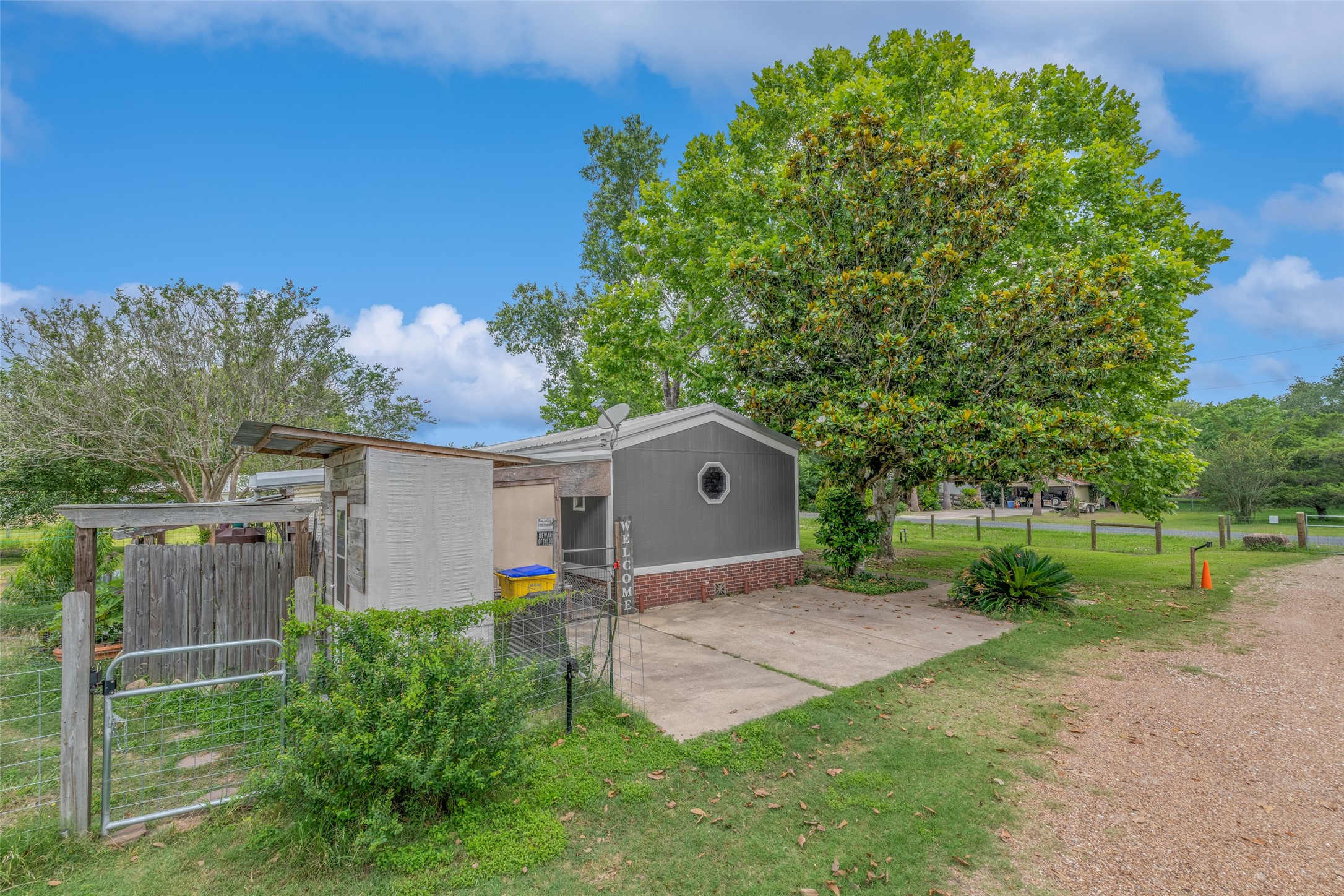 VIEW OF PARKING ON SIDE OF MOBILE HOME - If you have additional questions regarding 2055 Green Meadows Drive  in Sealy or would like to tour the property with us call 800-660-1022 and reference MLS# 16848431.