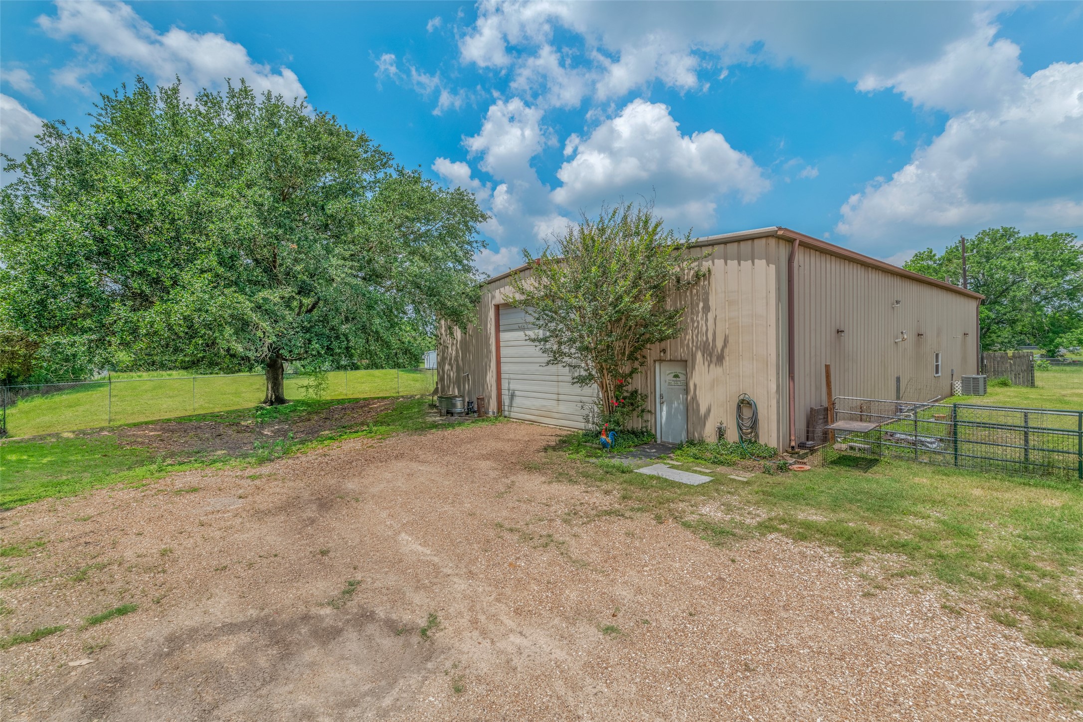 VIEW OF SHOP FROM DRIVEWAY - If you have additional questions regarding 2055 Green Meadows Drive  in Sealy or would like to tour the property with us call 800-660-1022 and reference MLS# 16848431.