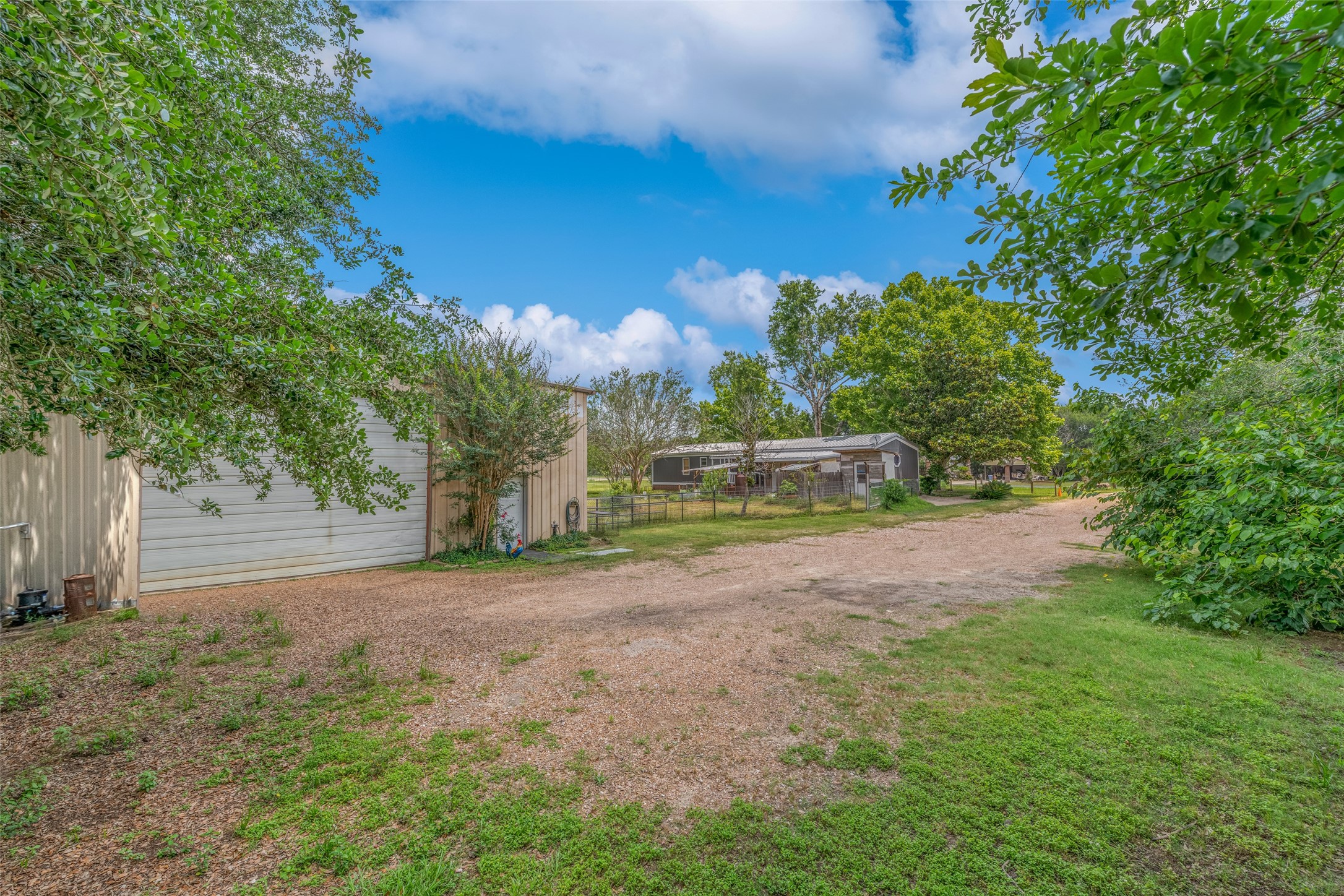 VIEW OF DRIVEWAY FROM BACK OF PROPERTY - If you have additional questions regarding 2055 Green Meadows Drive  in Sealy or would like to tour the property with us call 800-660-1022 and reference MLS# 16848431.