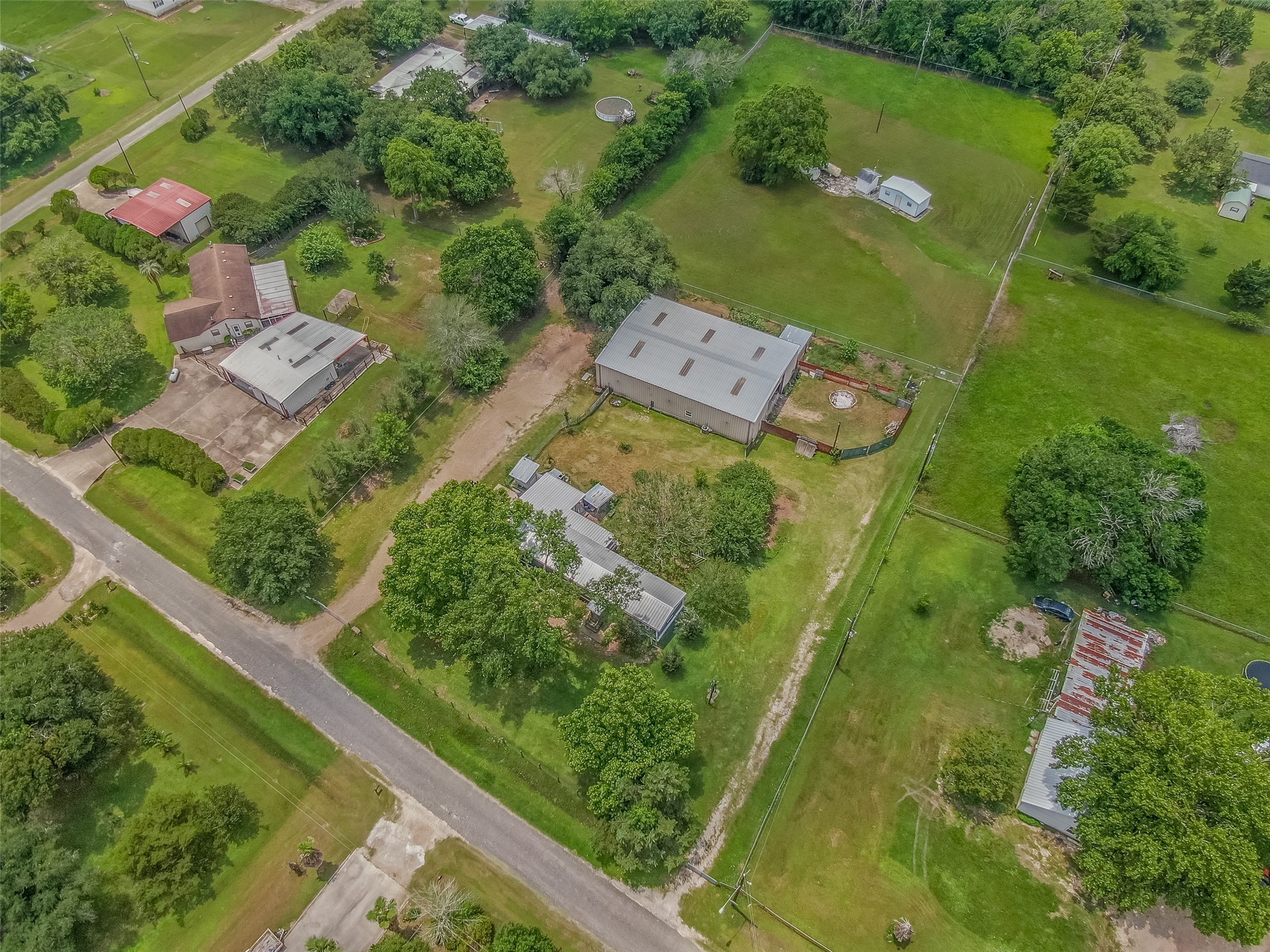 DRONE VIEW OF THE PROPERTY - If you have additional questions regarding 2055 Green Meadows Drive  in Sealy or would like to tour the property with us call 800-660-1022 and reference MLS# 16848431.