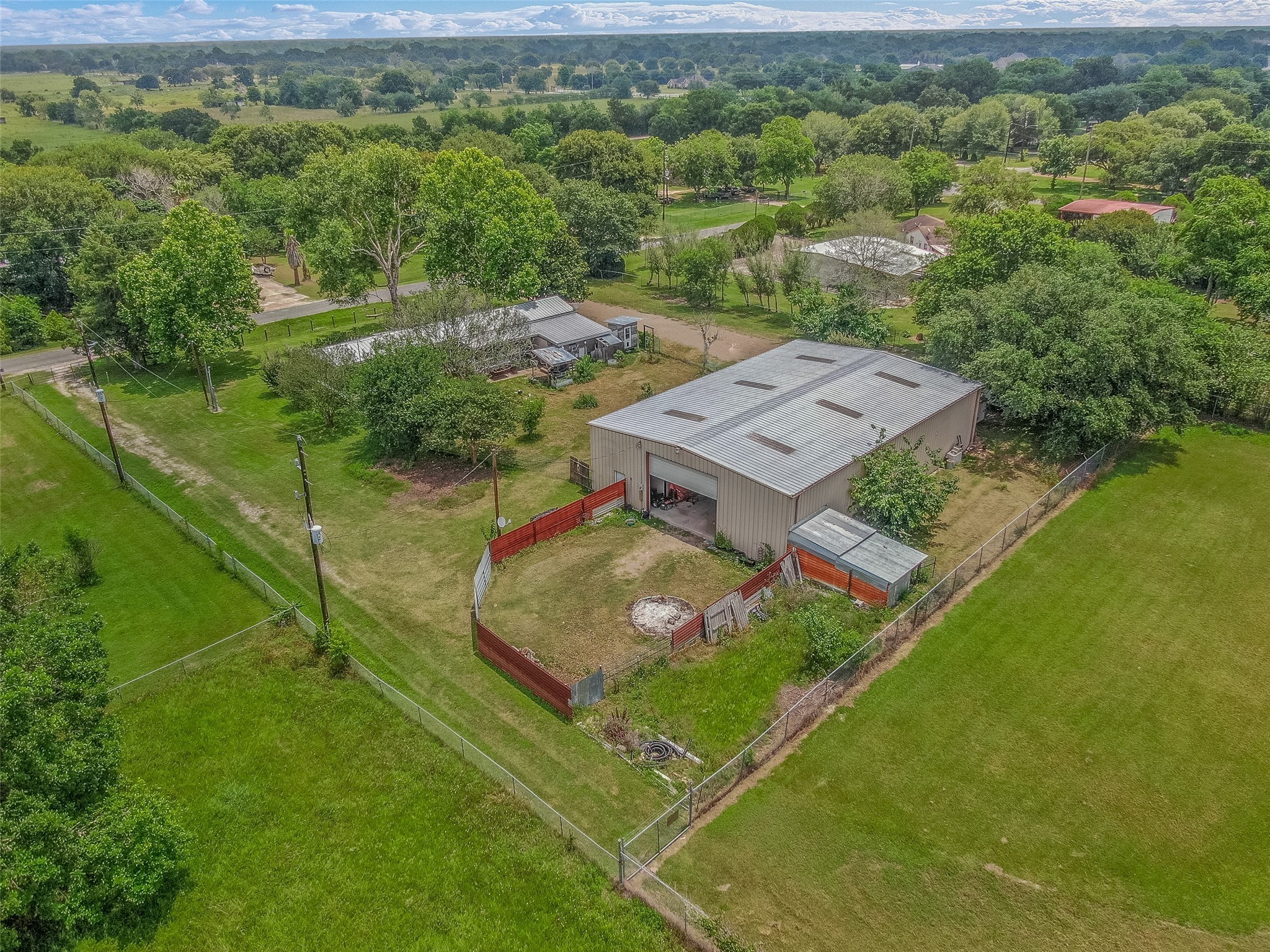 DRONE VIEW OF THE REAR OF PROPERTY - If you have additional questions regarding 2055 Green Meadows Drive  in Sealy or would like to tour the property with us call 800-660-1022 and reference MLS# 16848431.