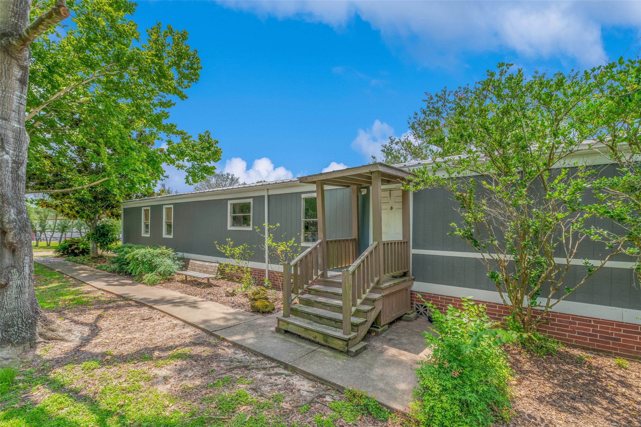 FRONT OF MOBILE HOME - If you have additional questions regarding 2055 Green Meadows Drive  in Sealy or would like to tour the property with us call 800-660-1022 and reference MLS# 16848431.