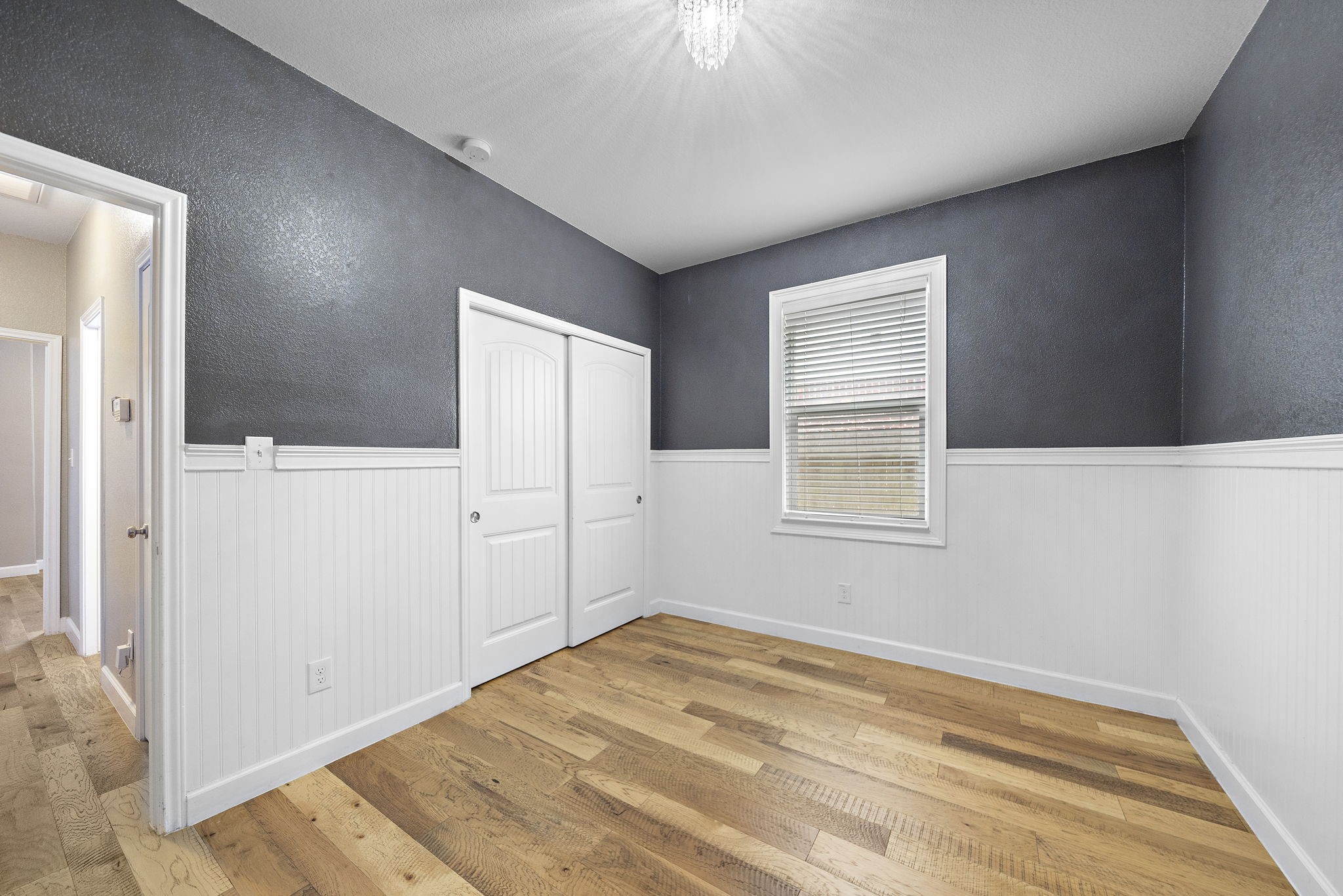 A secondary bedroom in this home features beadboard paneling, adding a touch of timeless charm and character. - If you have additional questions regarding 8307 Egret Bay Circle  in Baytown or would like to tour the property with us call 800-660-1022 and reference MLS# 61311135.