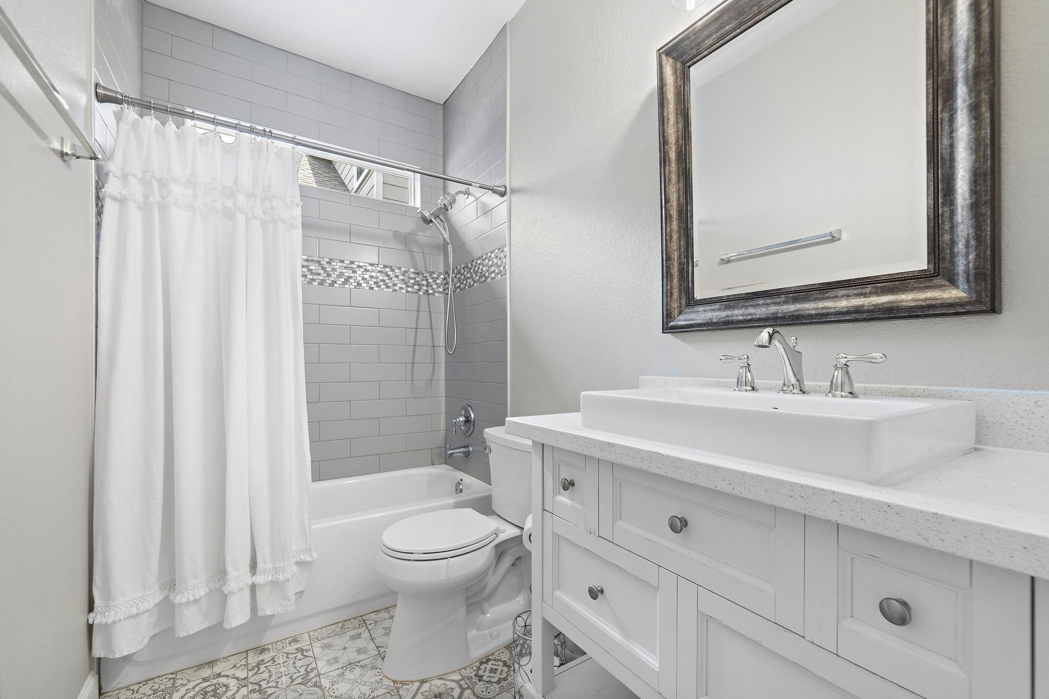 Discover the luxurious secondary bathroom featuring exquisite decorative tile and a custom vanity, creating a stylish and personalized retreat within this home. - If you have additional questions regarding 8307 Egret Bay Circle  in Baytown or would like to tour the property with us call 800-660-1022 and reference MLS# 61311135.