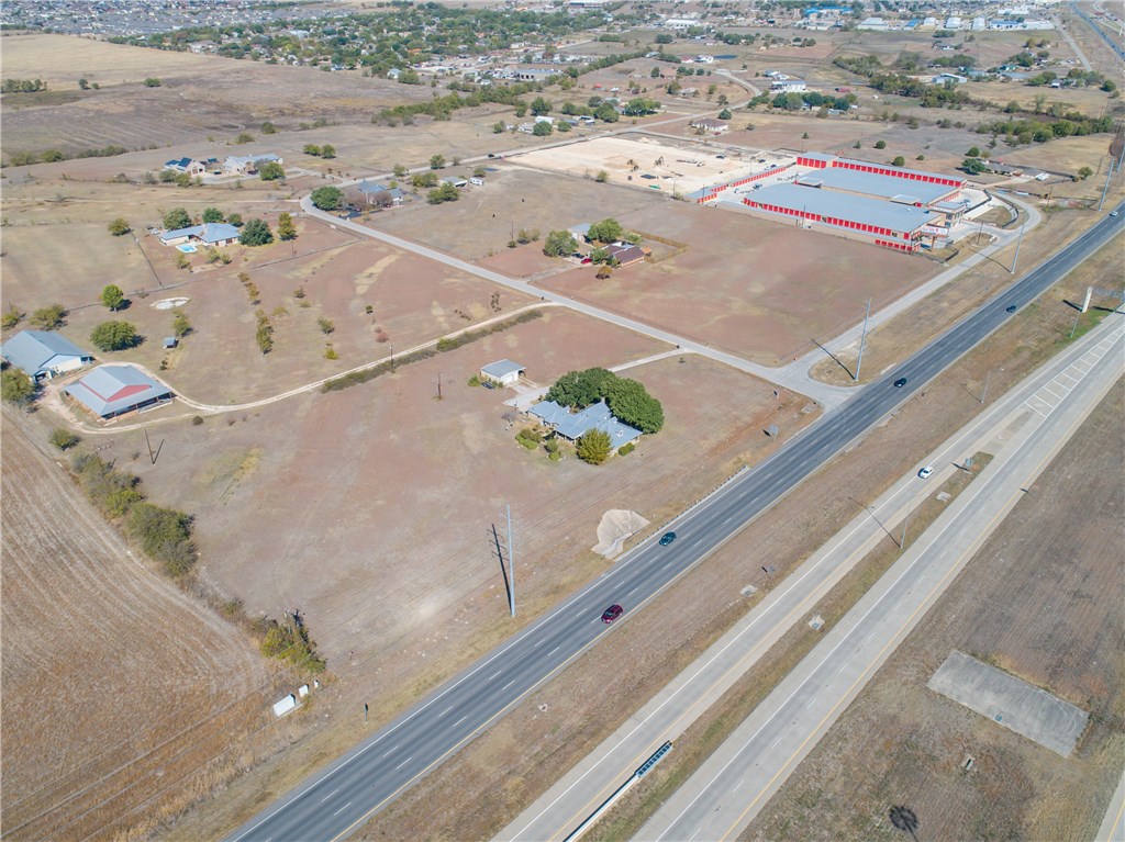 Aerial shot (home surrounded by trees) shows the reason Pflugerville Self Storage chose their land--thousands of rooftops nearby - If you have additional questions regarding 19806 Panther Drive  in Pflugerville or would like to tour the property with us call 800-660-1022 and reference MLS# 6240465.