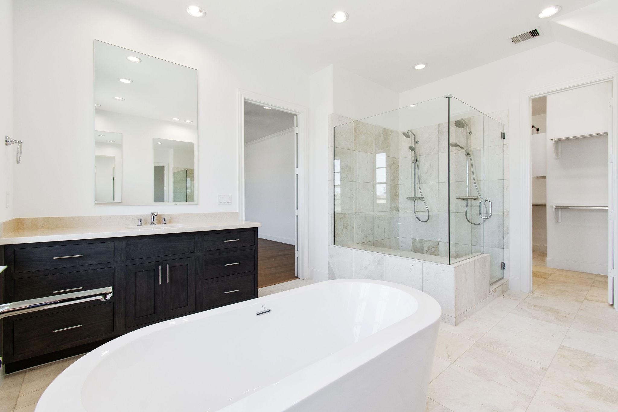 Gorgeous master bathroom with dual vanities, 6 ft soaker tub and seamless glass enclosed freestanding shower with two showerheads! - If you have additional questions regarding 6135 Cottage Grove Lake Drive  in Houston or would like to tour the property with us call 800-660-1022 and reference MLS# 93807520.