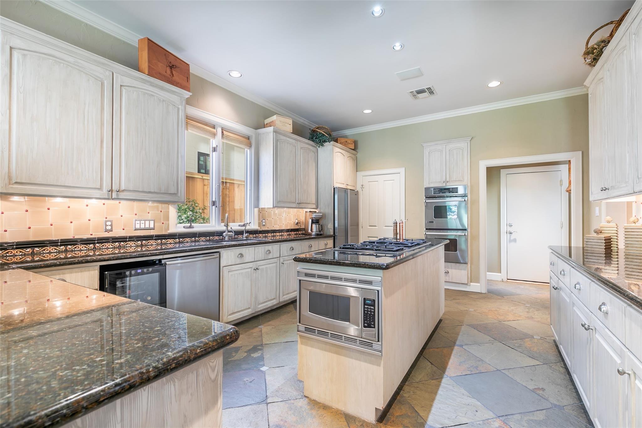 This kitchen boasts gas cooktop, double ovens, wine fridge and refrigerator/freezer to remain. - If you have additional questions regarding 3814 Purdue Street  in Houston or would like to tour the property with us call 800-660-1022 and reference MLS# 32310789.