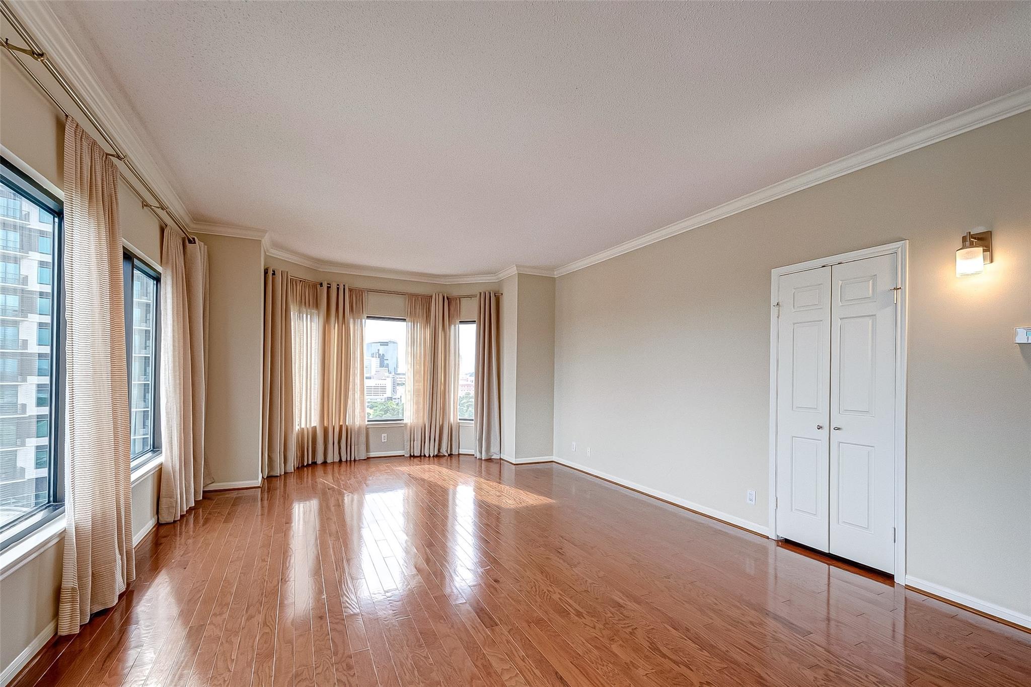 Master bedroom with sitting area, wood floors and great views. - If you have additional questions regarding 2001 Holcombe Boulevard  in Houston or would like to tour the property with us call 800-660-1022 and reference MLS# 64818655.