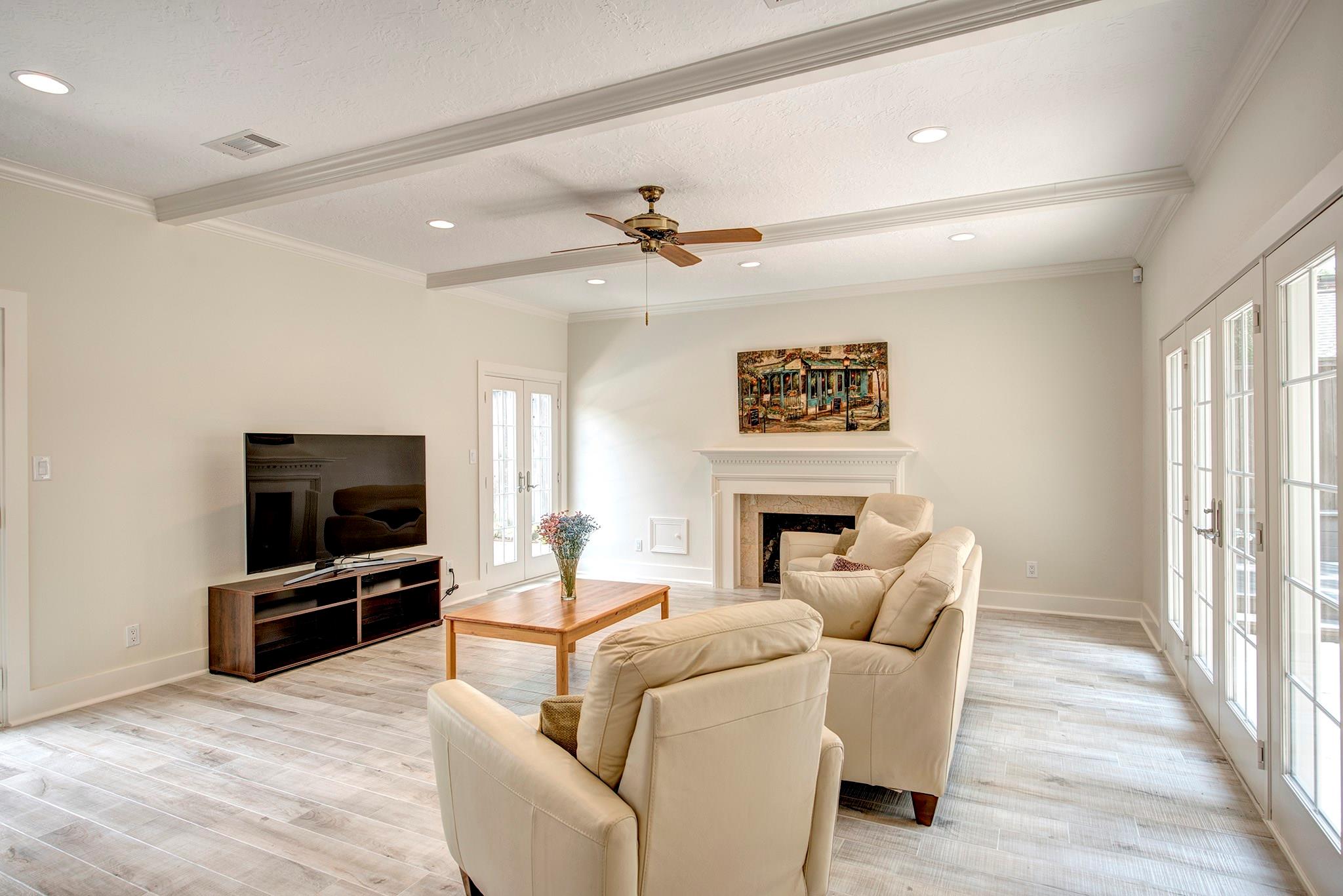 Alternate view of the Family Room featuring the gas log fireplace. There are two sets of double doors to access the pool! - If you have additional questions regarding 12326 Tunbridge Lane  in Houston or would like to tour the property with us call 800-660-1022 and reference MLS# 30688628.