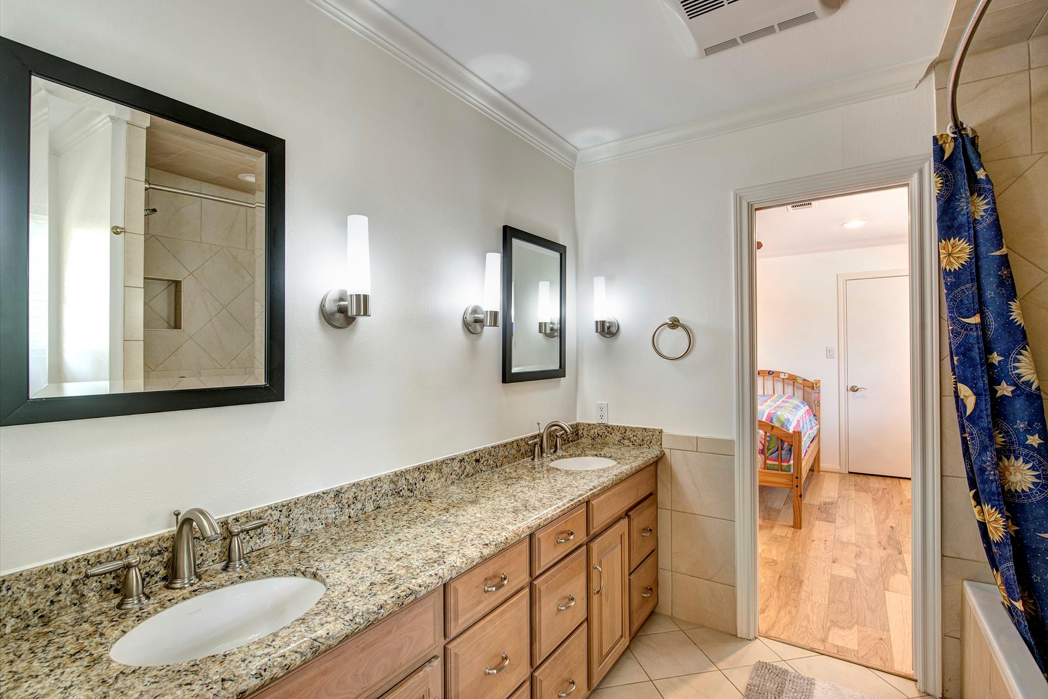 Bath between bedrooms two and three with two sinks, abundant drawers and tub/shower combination. - If you have additional questions regarding 12326 Tunbridge Lane  in Houston or would like to tour the property with us call 800-660-1022 and reference MLS# 30688628.