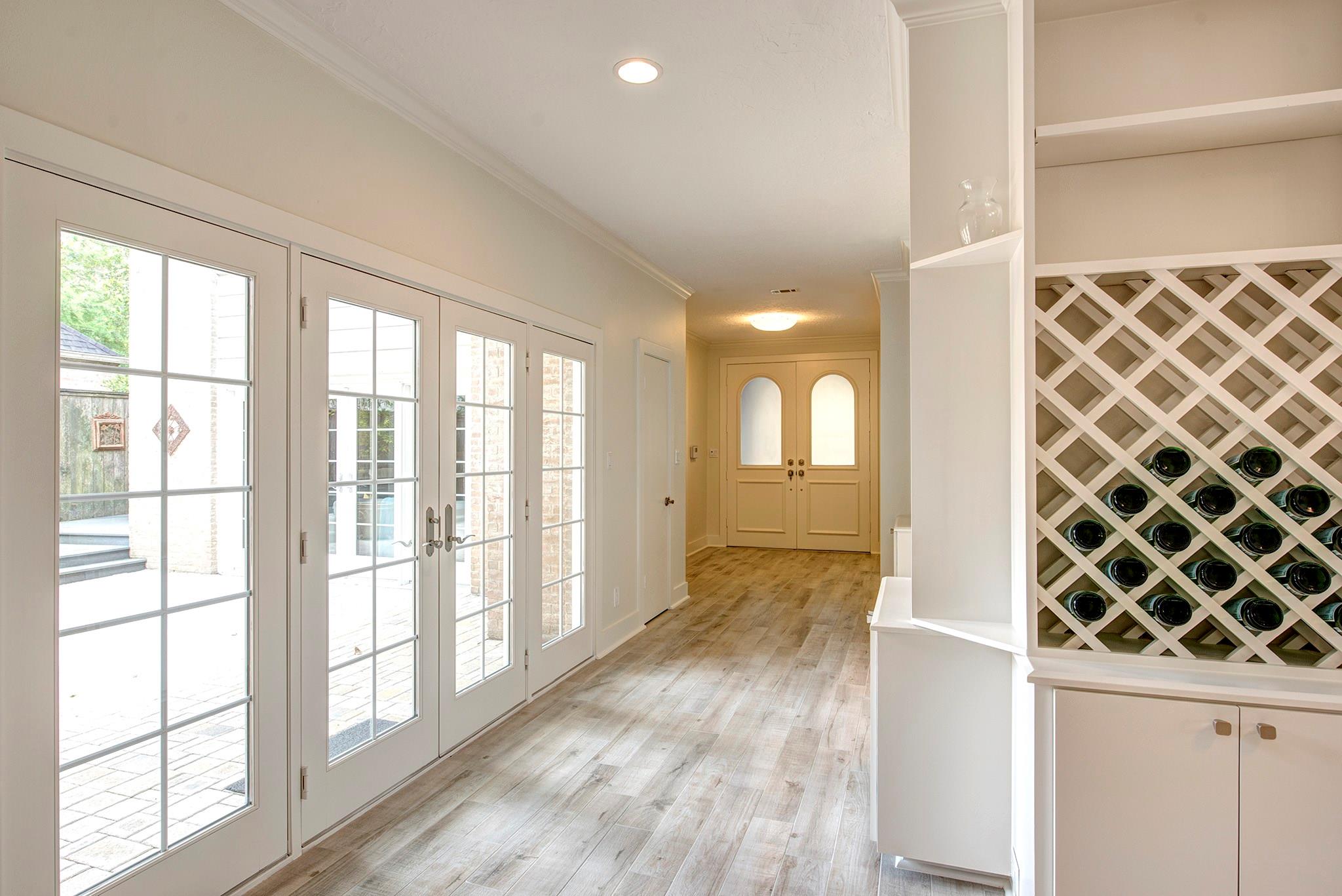 Alternate view of the entry hallway featuring double front doors and showcasing the large courtyard. - If you have additional questions regarding 12326 Tunbridge Lane  in Houston or would like to tour the property with us call 800-660-1022 and reference MLS# 30688628.