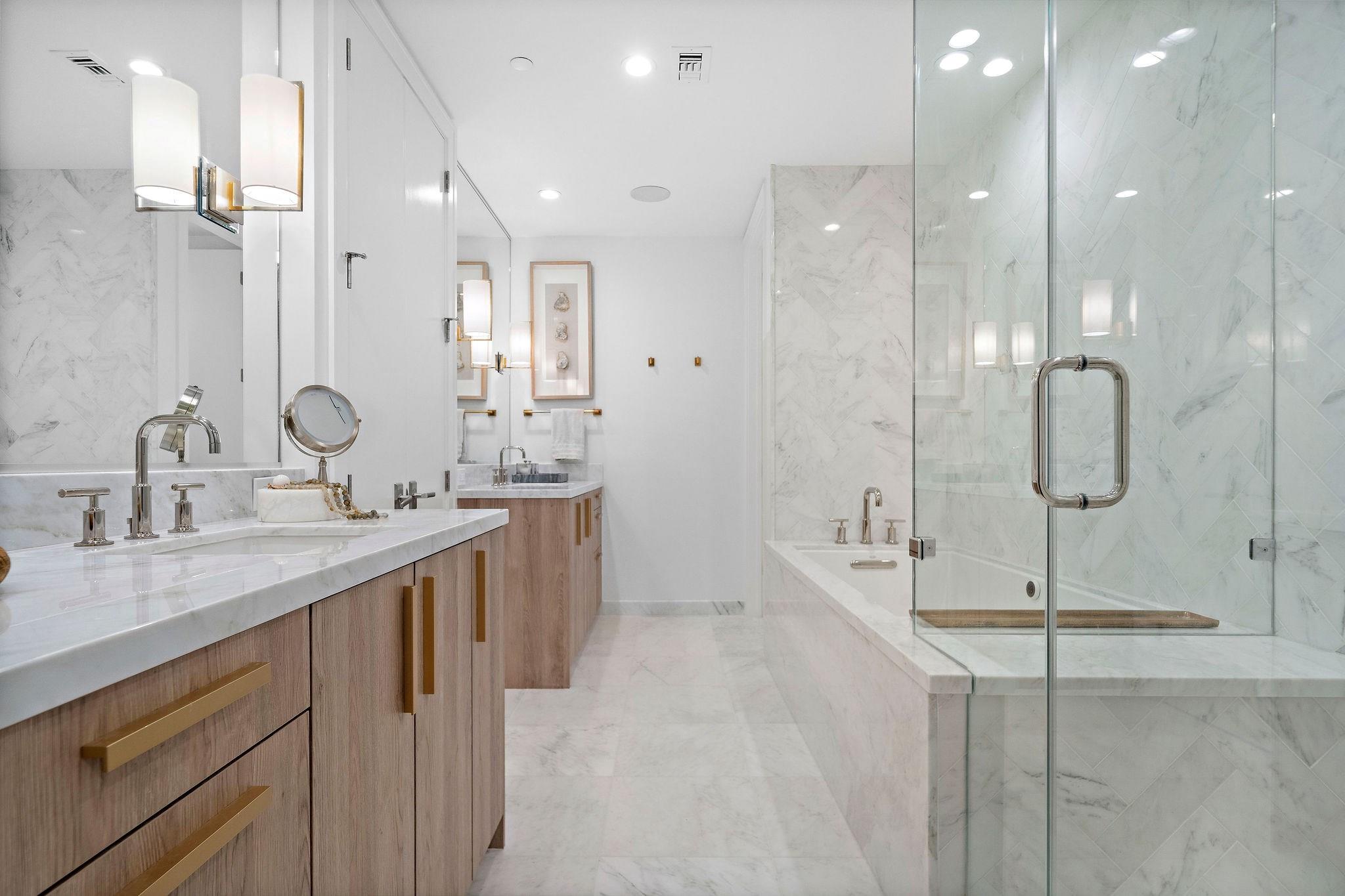 The stunningly beautiful primary bathroom is adorned with marble all over! From a slab tub surround, tile marble tub & shower surrounds, quartz countertops, and even marble floors. - If you have additional questions regarding 2047 Westcreek Lane  in Houston or would like to tour the property with us call 800-660-1022 and reference MLS# 10209475.