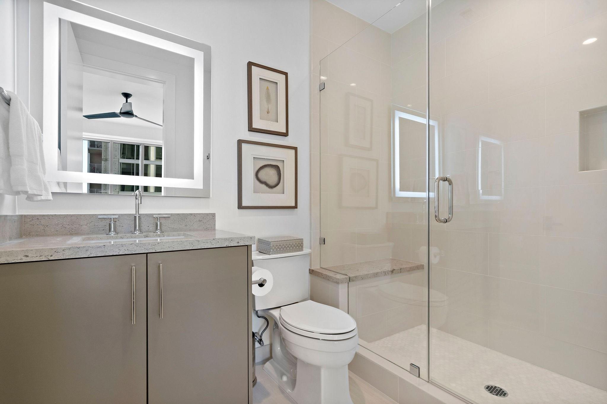 This full bath has a generous vanity space, a walk-in shower, and marble flooring. The lighted mirror serves as the highlight of this bathroom. - If you have additional questions regarding 2047 Westcreek Lane  in Houston or would like to tour the property with us call 800-660-1022 and reference MLS# 10209475.