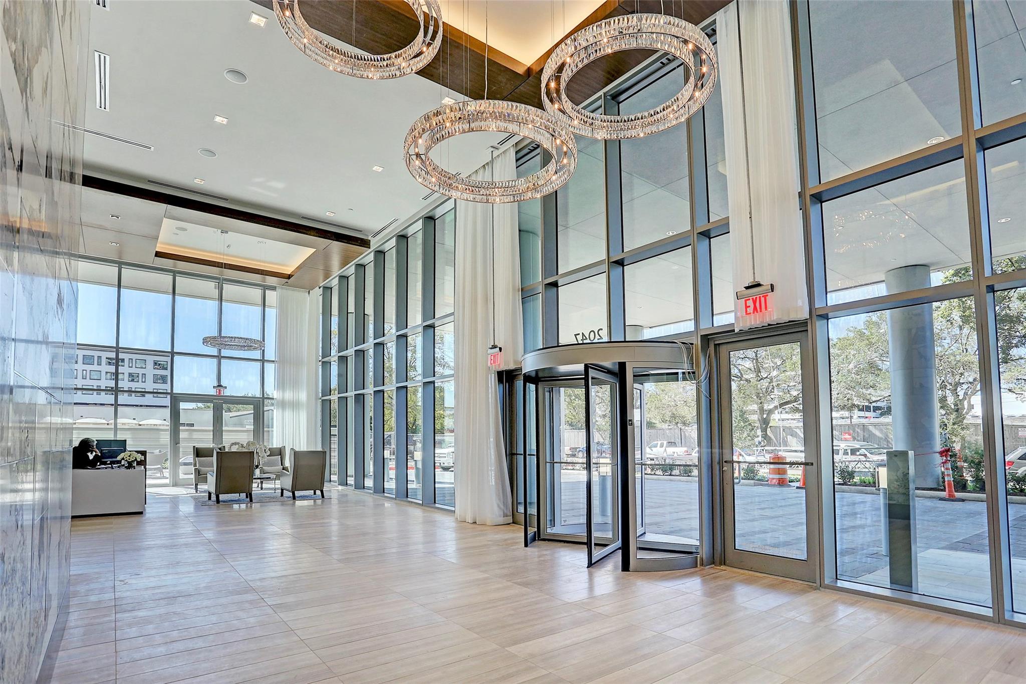 Gorgeously immaculate lobby with crystal chandeliers, floor to ceiling walls of glass, and decorative marble walls. The building offers 24-hour concierge services and valet parking. - If you have additional questions regarding 2047 Westcreek Lane  in Houston or would like to tour the property with us call 800-660-1022 and reference MLS# 10209475.