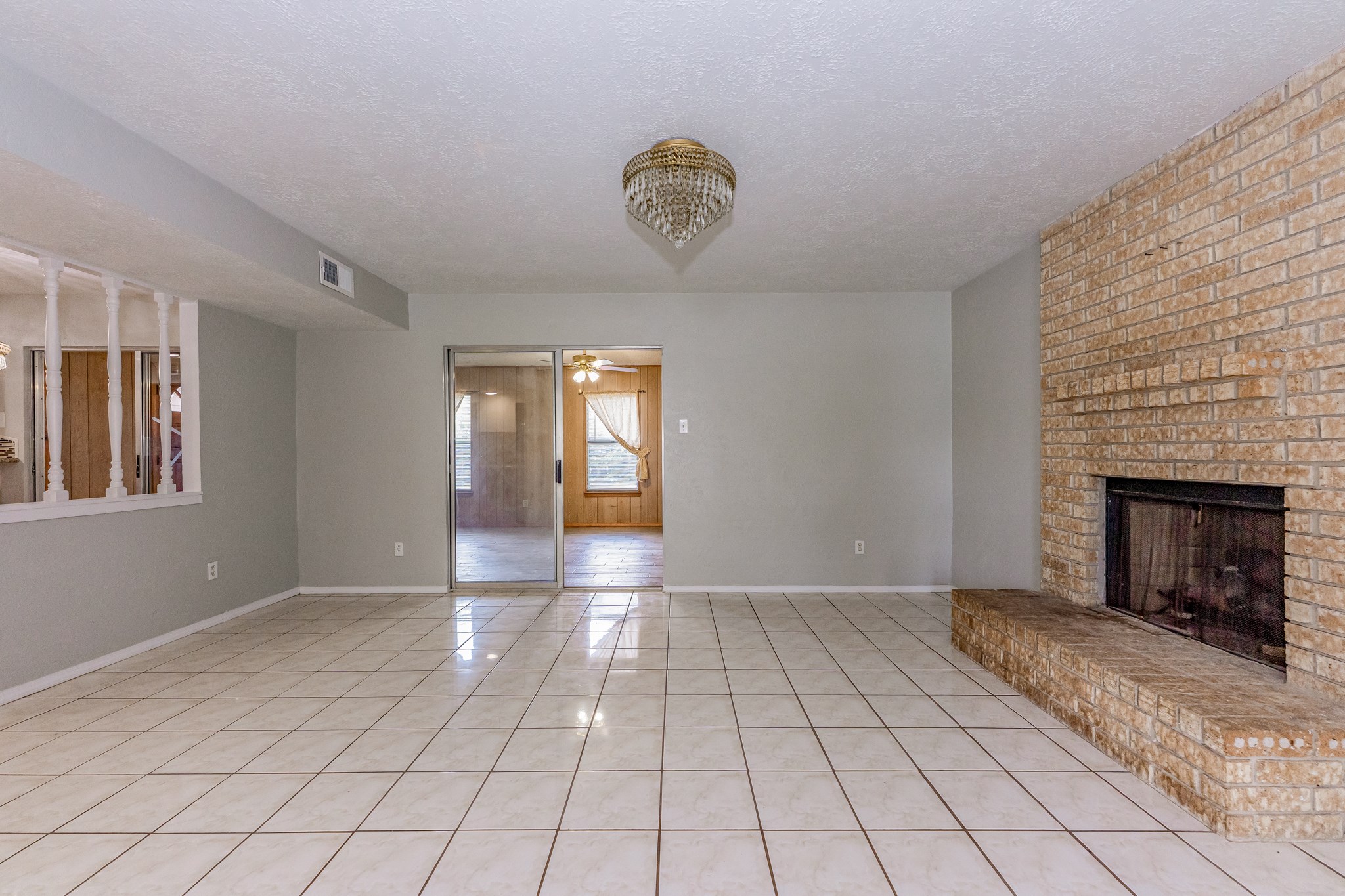 Family room with fire place and beautiful chandelier - If you have additional questions regarding 459 Woodrail Drive  in Houston or would like to tour the property with us call 800-660-1022 and reference MLS# 22334908.