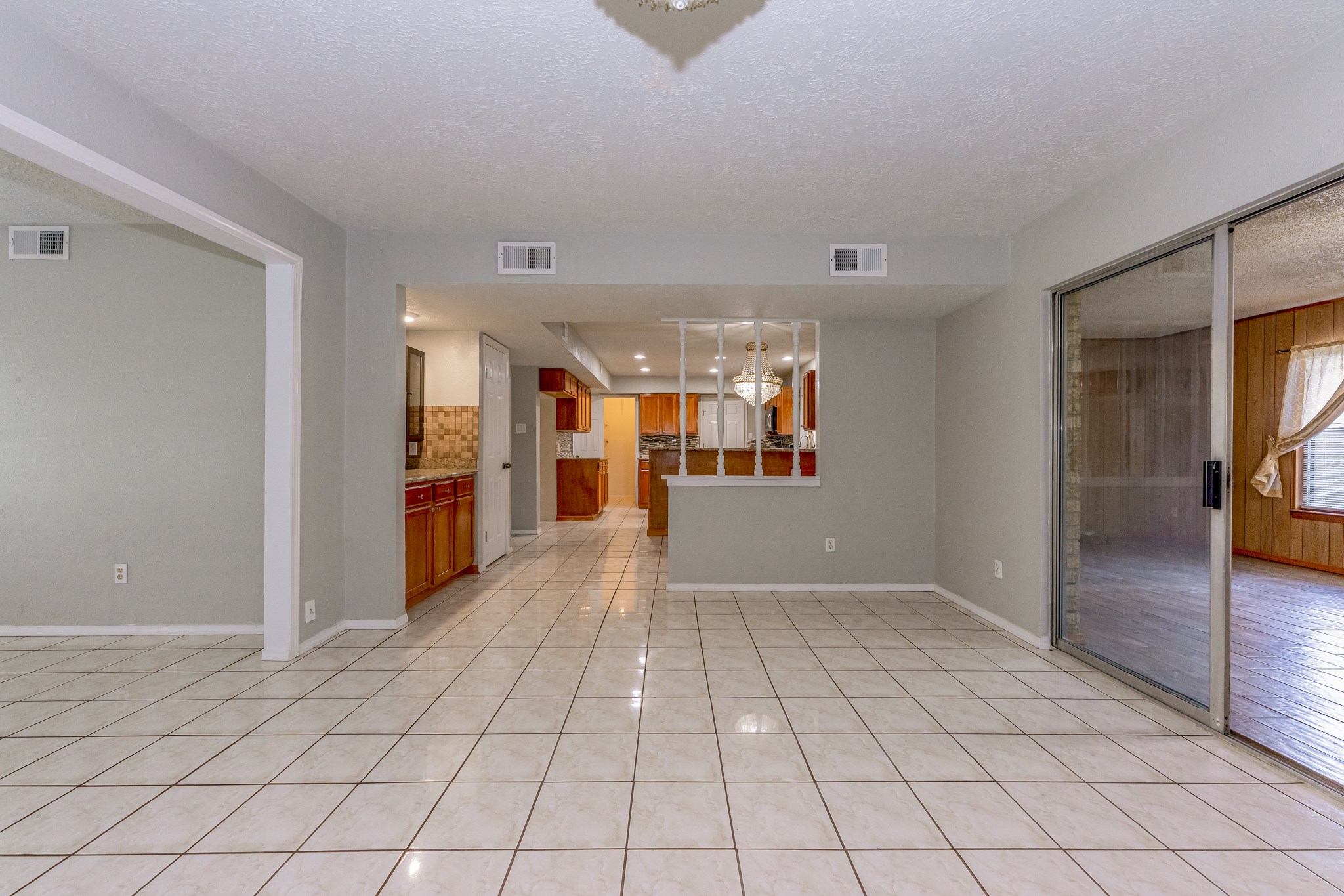 the living room is open, bright and airy with beautiful chandelier. - If you have additional questions regarding 459 Woodrail Drive  in Houston or would like to tour the property with us call 800-660-1022 and reference MLS# 22334908.