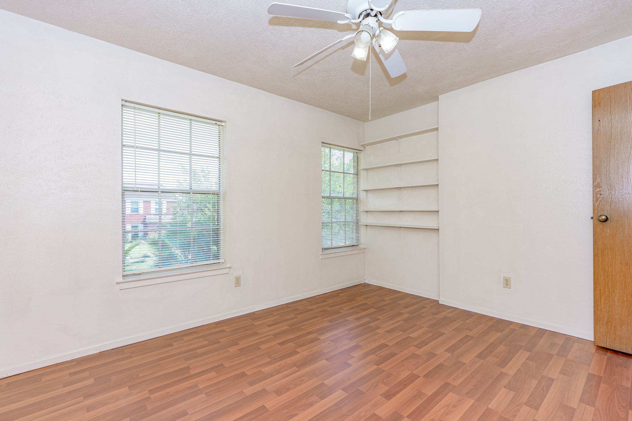 the third bedroom on the second floor with fan and laminate floor - If you have additional questions regarding 459 Woodrail Drive  in Houston or would like to tour the property with us call 800-660-1022 and reference MLS# 22334908.