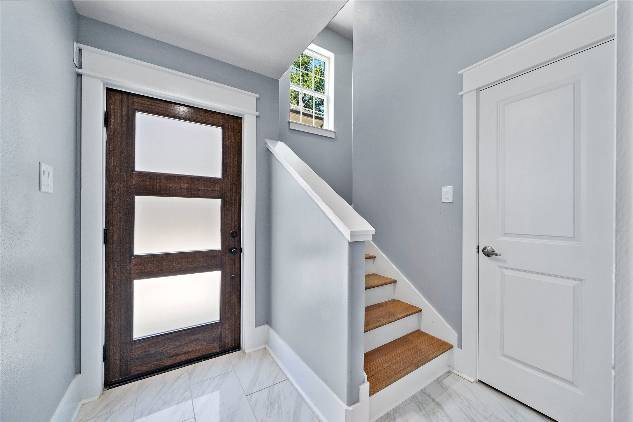 Take a look at this majestic front door that welcomes you once you enter your new modern and sophisticated townhouse! Notice how the door and the stairs stand out as they artistically contrast the color of the room. - If you have additional questions regarding 1521 Laird Street  in Houston or would like to tour the property with us call 800-660-1022 and reference MLS# 20251638.