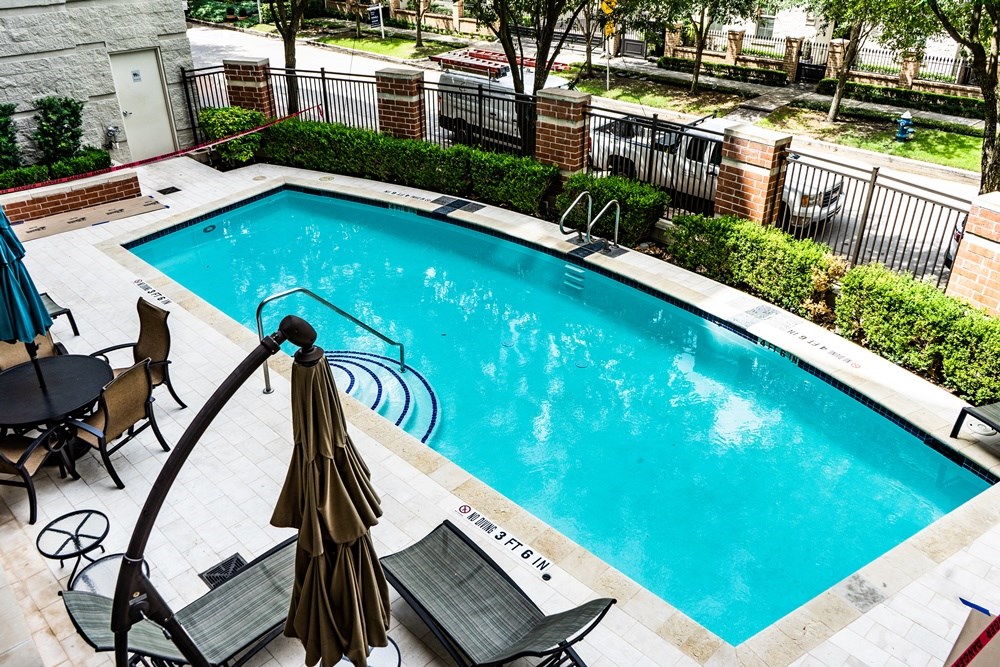 View of pool from balcony - If you have additional questions regarding 2211 Briarglen Drive  in Houston or would like to tour the property with us call 800-660-1022 and reference MLS# 95507108.