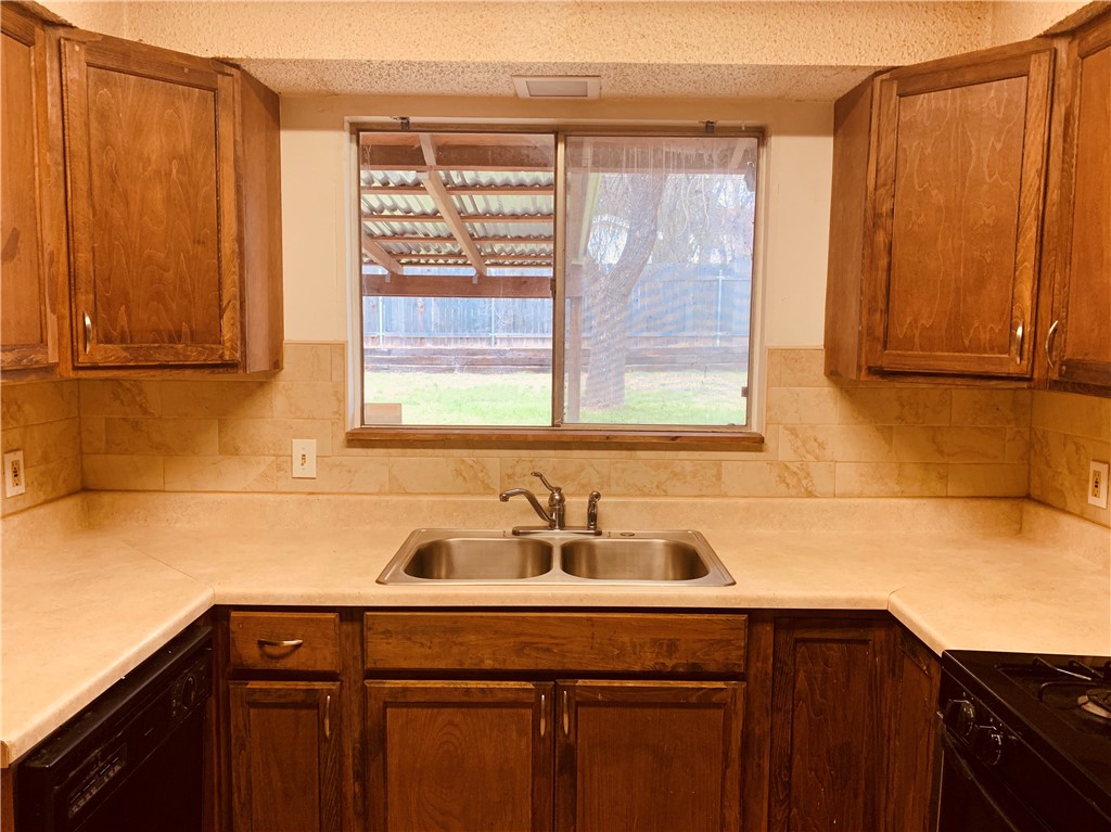 Great view of the Backyard from the Kitchen! - If you have additional questions regarding 7302 Glenhill Road  in Austin or would like to tour the property with us call 800-660-1022 and reference MLS# 3923725.