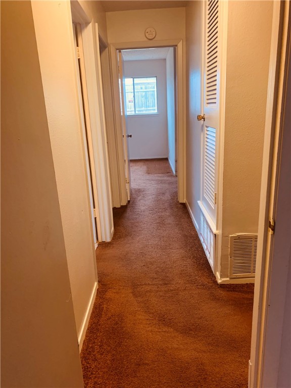 Long hallway between rooms. - If you have additional questions regarding 7302 Glenhill Road  in Austin or would like to tour the property with us call 800-660-1022 and reference MLS# 3923725.
