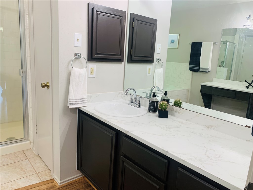 Master bath with separate vanities - upgraded countertops, sinks, faucets, lighting, and toilets - If you have additional questions regarding 4512 Sojourner Street  in Austin or would like to tour the property with us call 800-660-1022 and reference MLS# 8935600.