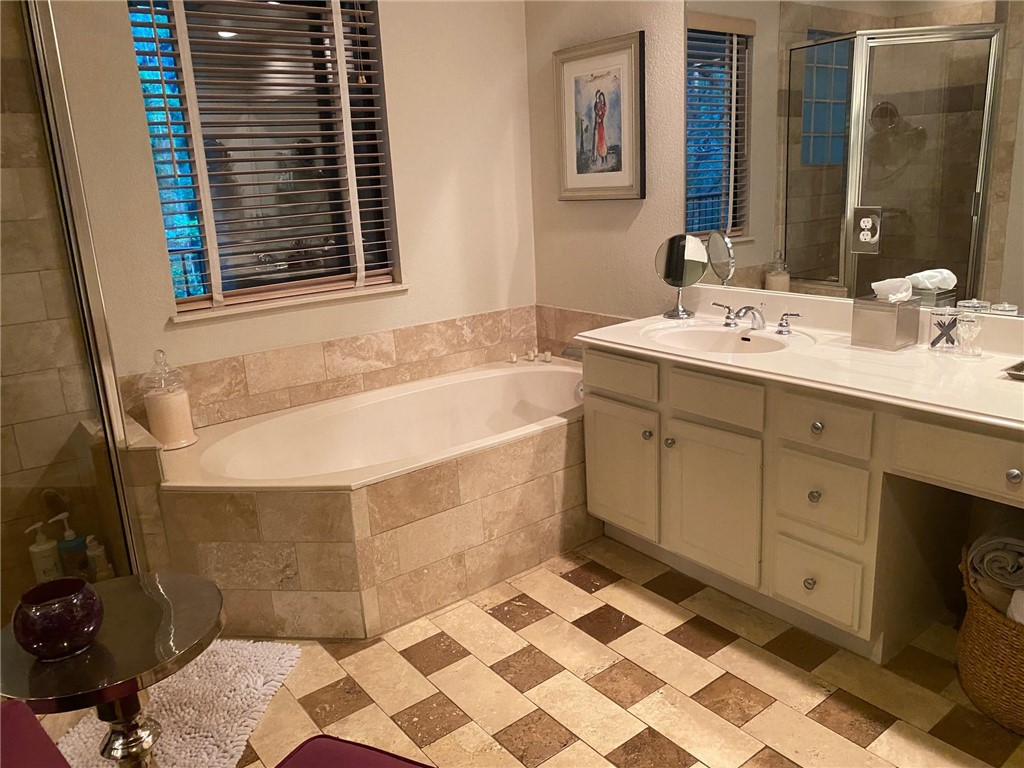 Primary bathroom with jetted tub, double vanity, walk-in closet and more closet/linen space - If you have additional questions regarding 1000 Liberty Park Drive  in Austin or would like to tour the property with us call 800-660-1022 and reference MLS# 2545624.