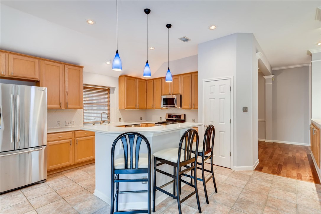 The bright & open Kitchen has a large center island with a breakfast bar & Stainless Steel appliances.  The refrigerator stays in the home. - If you have additional questions regarding 9009 Lantana Way  in Austin or would like to tour the property with us call 800-660-1022 and reference MLS# 6335387.