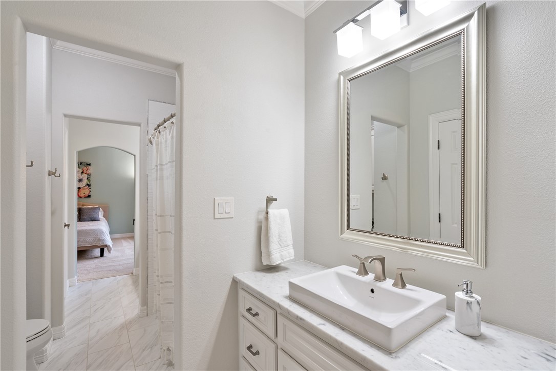 These two bedrooms share a shower that is finished with contemporary white tile and window for light. - If you have additional questions regarding 2904 MEANDERING RIVER Court  in Austin or would like to tour the property with us call 800-660-1022 and reference MLS# 1563524.