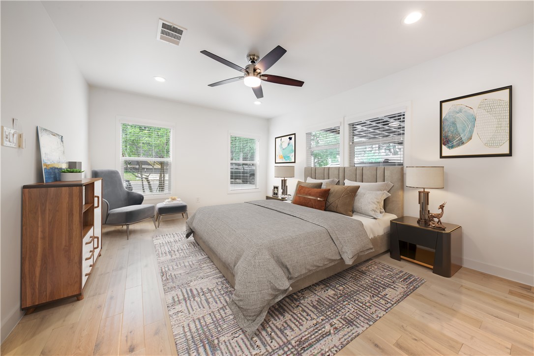 Virtually staged primary bedroom.  Primary bathroom on right. - If you have additional questions regarding 1408 Summit Street  in Austin or would like to tour the property with us call 800-660-1022 and reference MLS# 6576935.